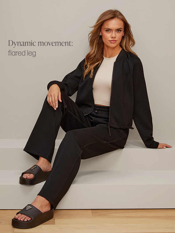 image of a model in a matching black activewear set with flared leg sweatpants