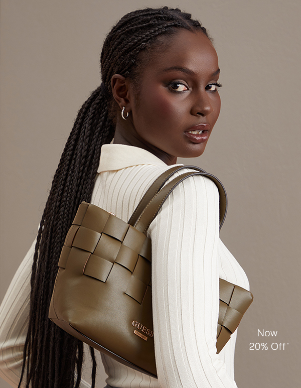 image of a model in a white sweater with a woven olive-green leather handbag