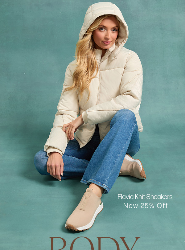 image of a model in a white puffer jacket with tan stretch-knit sneakers