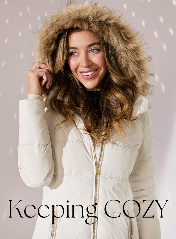 image of a model in a cream quilted nylon puffer jacket with fur-trim hood