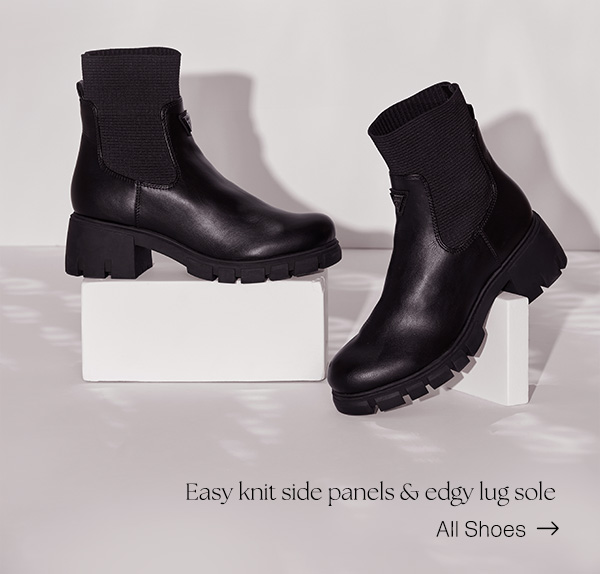 image of a pair of black faux-leather ankle boots with knit side panels and lug sole