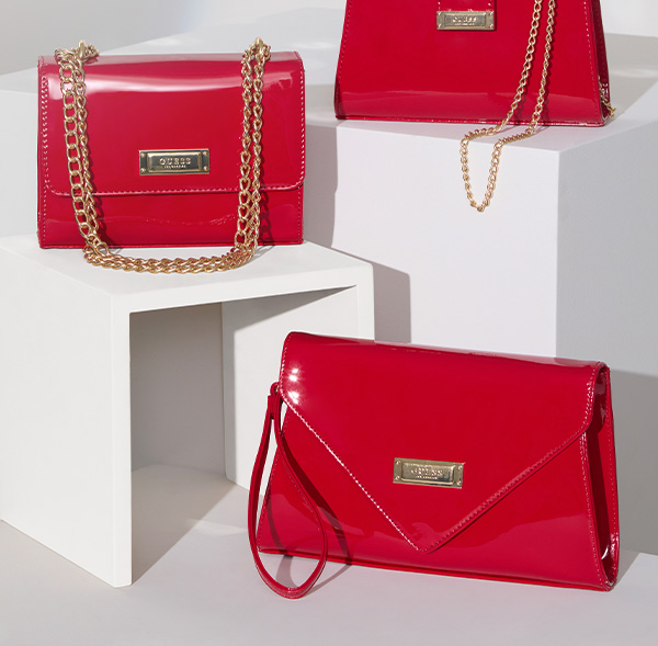 image of three faux patent-leather candy apple red handbags in various silhouettes