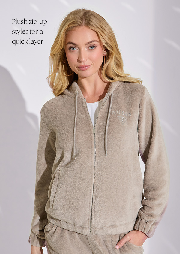 image of a model in a cream pullover hoodie with rhinestone script logo design