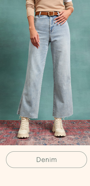 image of a model in light-wash denim wide leg jeans with cropped ankle fit