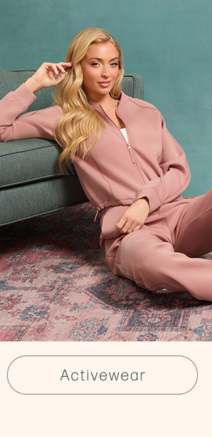 image of a model in a pink zip-up sweatshirt and matching active sweatpants