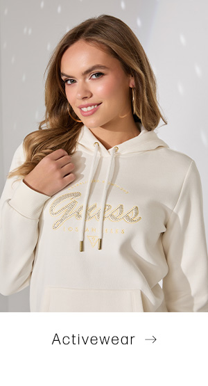 image of a model in a cream hoodie with sparkling script logo 